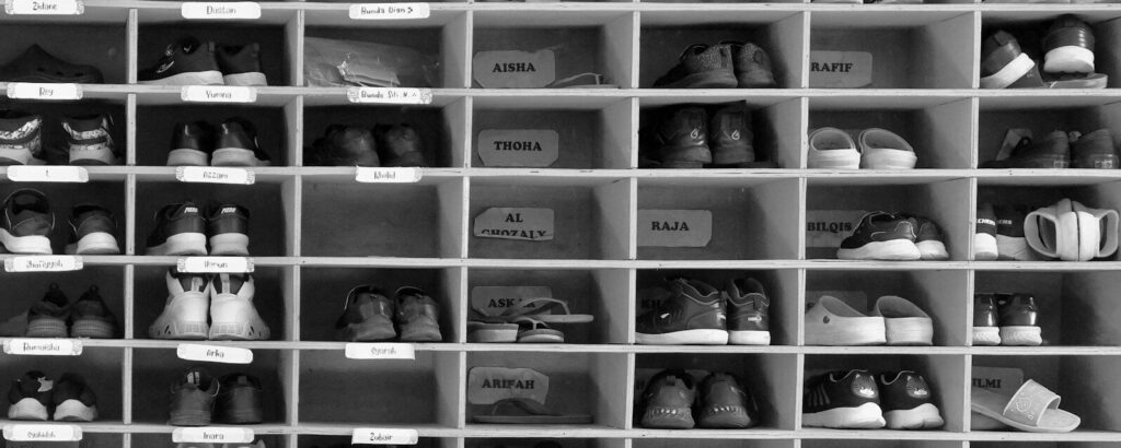 A shelf filled with lots of pairs of shoes