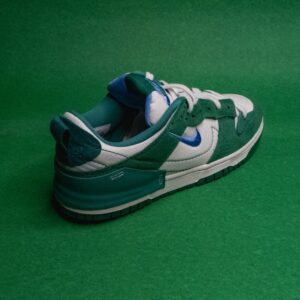 a green and black shoe on a green surface